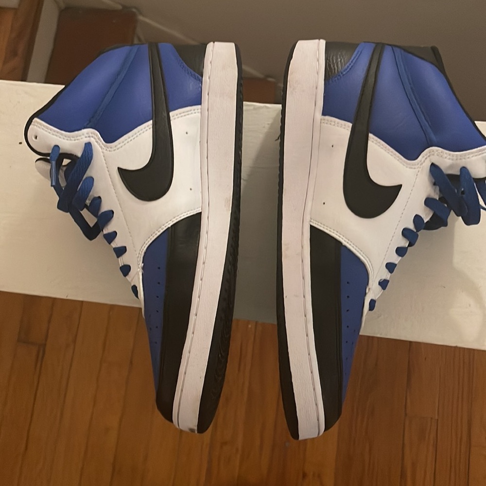 Blue black and white Nikes mid tops